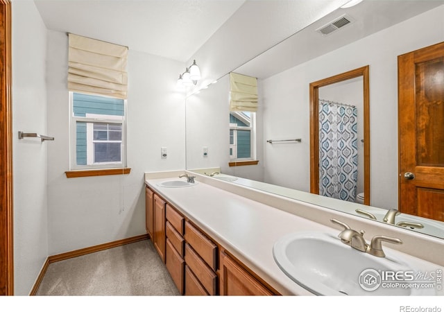 502 Peregrine Cir, Longmont, CO 80504 - bathroom featuring double vanity and plenty of natural light