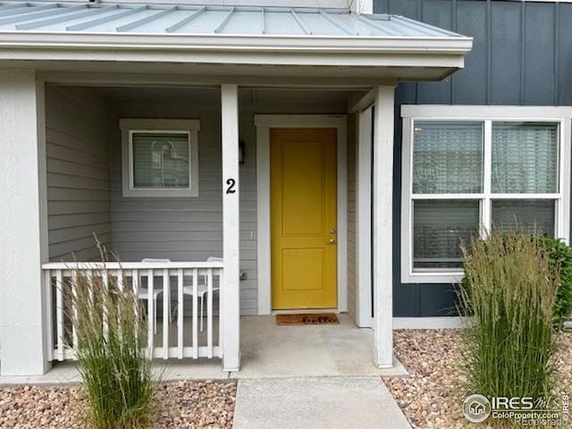 6340 Orchard Park Dr Unit 2, Greeley, CO 80634 - property entrance featuring a porch, a standing seam roof, board and batten siding, and a metal roof