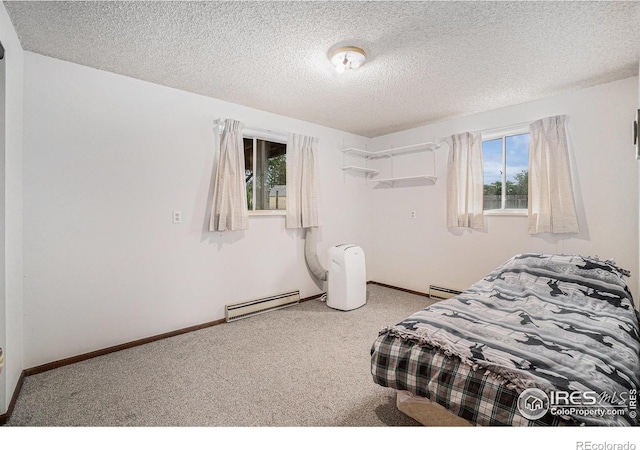 37416 County Road 45, Eaton, CO 80615 - bedroom featuring baseboard heating, carpet floors, a textured ceiling, and a baseboard heating unit