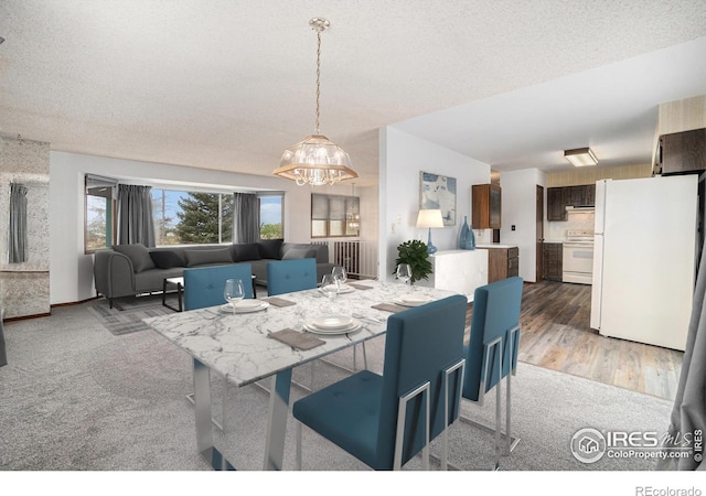37416 County Road 45, Eaton, CO 80615 - carpeted dining space with a chandelier and a textured ceiling