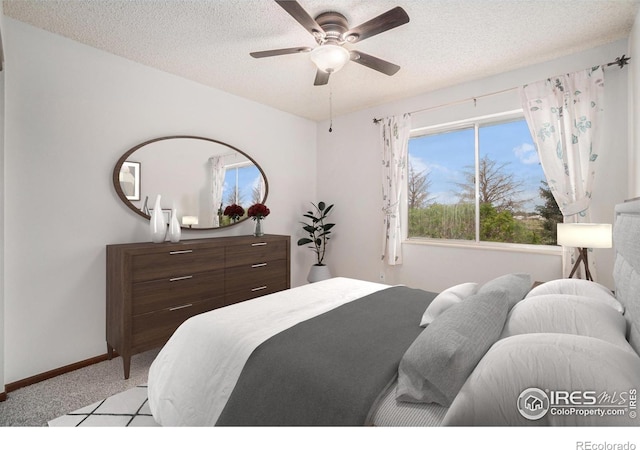 37416 County Road 45, Eaton, CO 80615 - bedroom featuring light carpet, multiple windows, a textured ceiling, and ceiling fan
