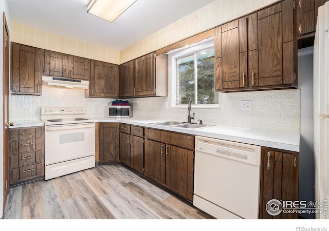 37416 County Road 45, Eaton, CO 80615 - kitchen with white appliances, under cabinet range hood, tasteful backsplash, and light countertops