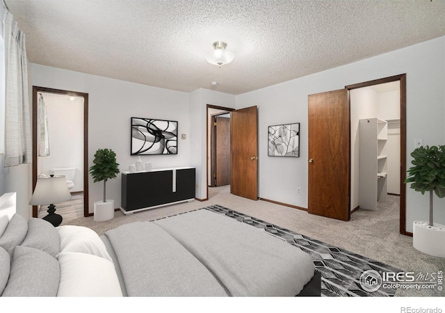 37416 County Road 45, Eaton, CO 80615 - carpeted bedroom with a textured ceiling, a walk in closet, and connected bathroom