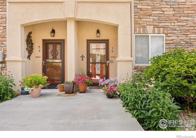 1703 Whitehall Dr Unit G, Longmont, CO 80504 - view of exterior entry featuring stone siding and stucco siding