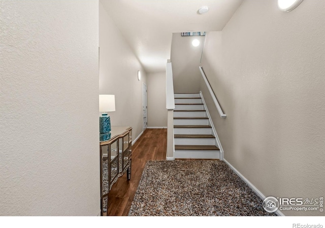 1703 Whitehall Dr Unit G, Longmont, CO 80504 - staircase featuring wood finished floors and baseboards