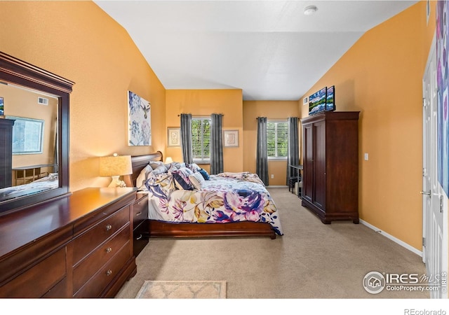 1703 Whitehall Dr Unit G, Longmont, CO 80504 - bedroom featuring vaulted ceiling and light colored carpet
