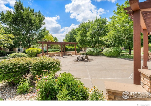 1703 Whitehall Dr Unit G, Longmont, CO 80504 - view of patio / terrace featuring a pergola and an outdoor fire pit