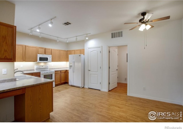 4672 W 20th Street Rd Unit 1311, Greeley, CO 80634 - kitchen with white appliances, a ceiling fan, light wood-style flooring, track lighting, and light countertops