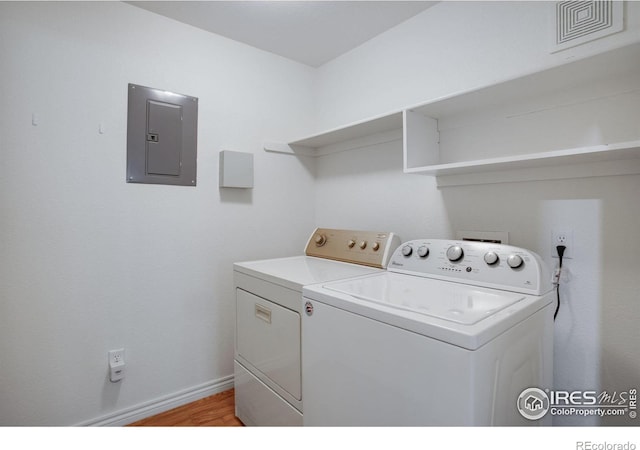 4672 W 20th Street Rd Unit 1311, Greeley, CO 80634 - laundry area featuring electric panel, washing machine and dryer, and light wood-style flooring