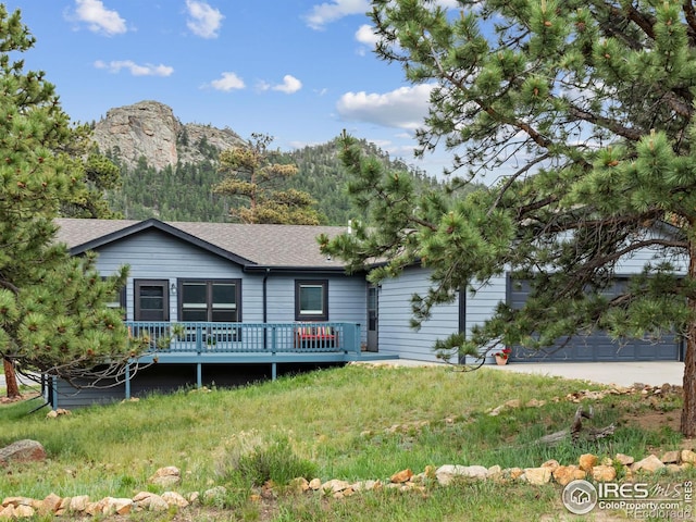 1316 Kinnikinnic Ct, Estes Park, CO 80517 - view of front of property featuring a deck with mountain view and roof with shingles
