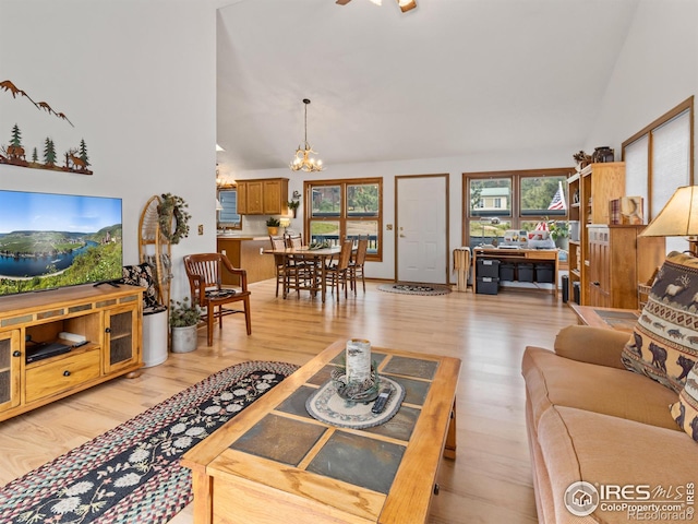 1316 Kinnikinnic Ct, Estes Park, CO 80517 - living room with a chandelier, high vaulted ceiling, and light wood finished floors