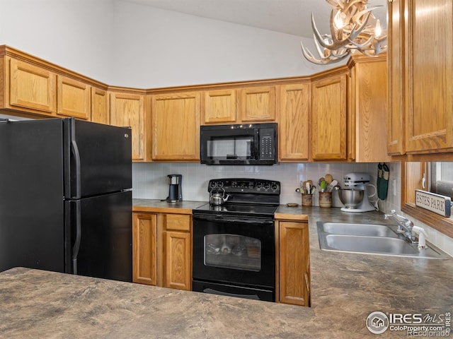 1316 Kinnikinnic Ct, Estes Park, CO 80517 - kitchen featuring black appliances, vaulted ceiling, tasteful backsplash, a chandelier, and dark countertops