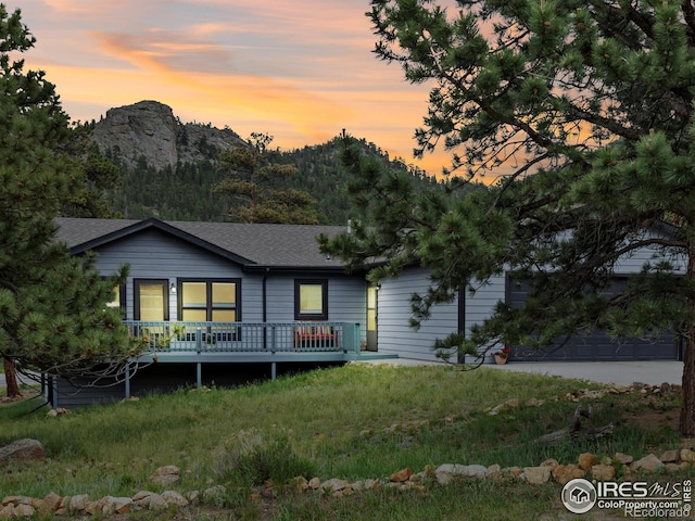 1316 Kinnikinnic Ct, Estes Park, CO 80517 - view of front of property with a wooden deck and a shingled roof
