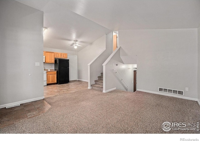 1634 San Juan Cir, Evans, CO 80620 - unfurnished living room with a ceiling fan, stairs, and light colored carpet