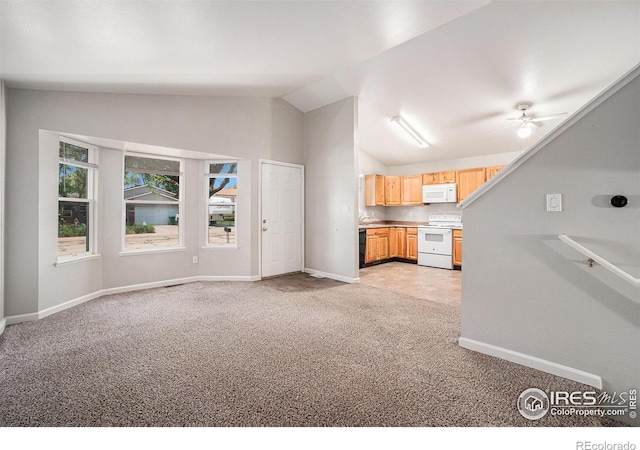 1634 San Juan Cir, Evans, CO 80620 - kitchen with white appliances, light colored carpet, vaulted ceiling, light brown cabinetry, and a ceiling fan