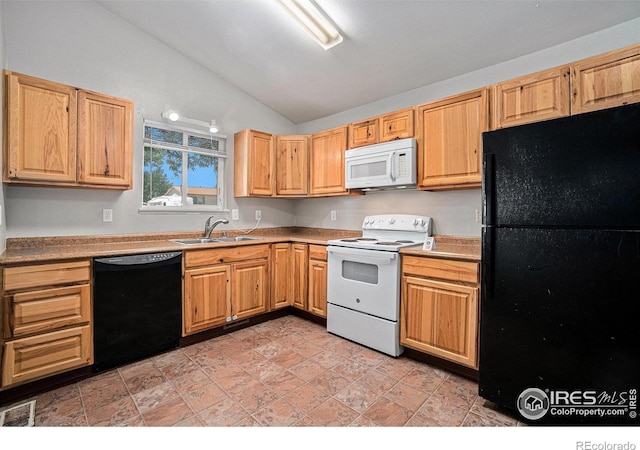 1634 San Juan Cir, Evans, CO 80620 - kitchen featuring black appliances, lofted ceiling, light countertops, and light brown cabinetry
