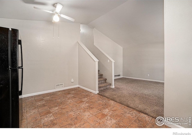 1634 San Juan Cir, Evans, CO 80620 - below grade area with freestanding refrigerator, ceiling fan, stone finish flooring, stairs, and carpet