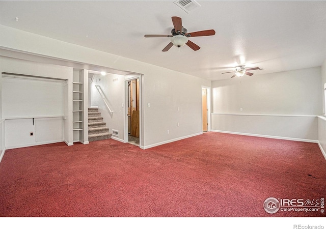 1634 San Juan Cir, Evans, CO 80620 - spare room featuring stairway, carpet floors, a ceiling fan, and built in shelves