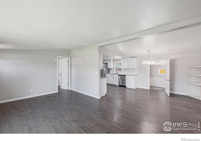 8416 Peakview Dr, Fort Collins, CO 80528 - unfurnished living room with a chandelier, a textured ceiling, and dark wood-style floors