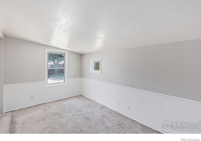 8416 Peakview Dr, Fort Collins, CO 80528 - unfurnished room featuring a wainscoted wall, a textured ceiling, and carpet floors