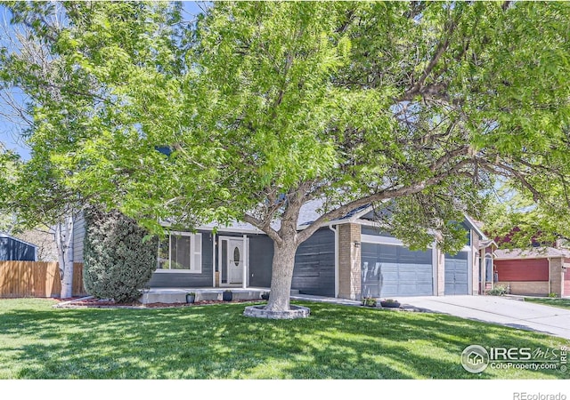 5491 E 117th Ave, Thornton, CO 80233 - obstructed view of property featuring concrete driveway, brick siding, and a garage