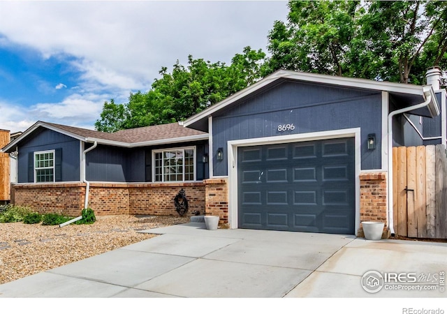 8696 W 86th Cir, Arvada, CO 80005 - ranch-style house featuring a garage, concrete driveway, brick siding, and roof with shingles