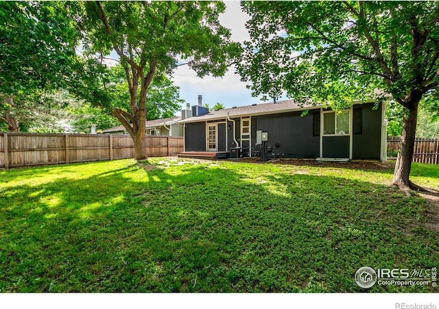 8696 W 86th Cir, Arvada, CO 80005 - rear view of property with a sunroom, a fenced backyard, and a chimney