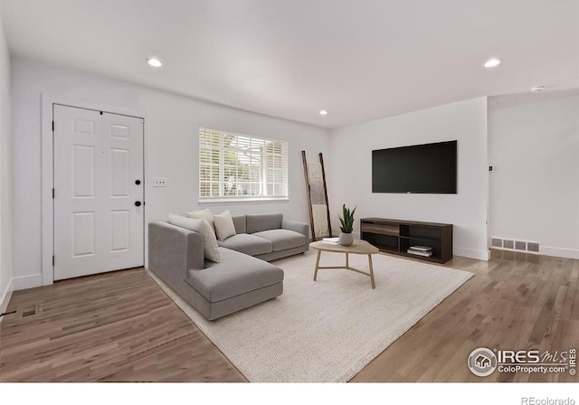 8696 W 86th Cir, Arvada, CO 80005 - living room with light wood finished floors and recessed lighting