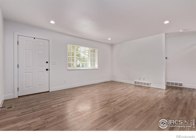 8696 W 86th Cir, Arvada, CO 80005 - unfurnished living room featuring wood finished floors and recessed lighting