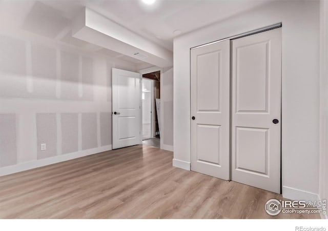 8696 W 86th Cir, Arvada, CO 80005 - unfurnished bedroom with light wood finished floors and a closet