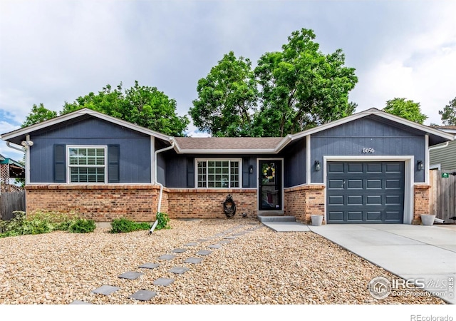 8696 W 86th Cir, Arvada, CO 80005 - ranch-style home featuring brick siding, a garage, and driveway