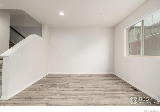 619 Brennan Cir, Erie, CO 80516 - unfurnished room with recessed lighting, light wood-type flooring, and stairway