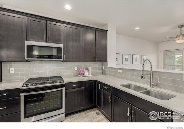 619 Brennan Cir, Erie, CO 80516 - kitchen featuring stainless steel appliances, tasteful backsplash, a ceiling fan, and recessed lighting