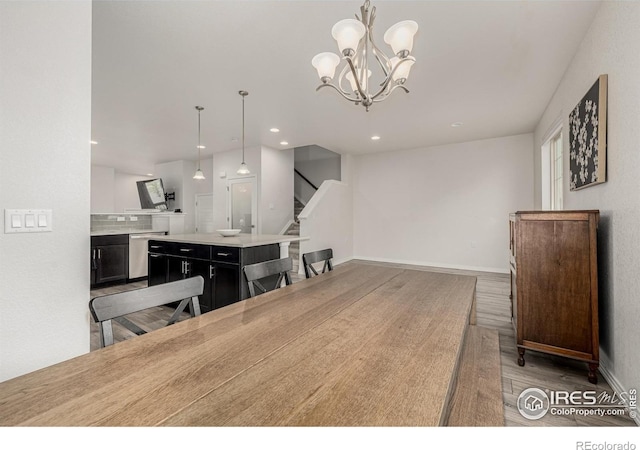 619 Brennan Cir, Erie, CO 80516 - dining space with wood finished floors, recessed lighting, stairway, and a chandelier