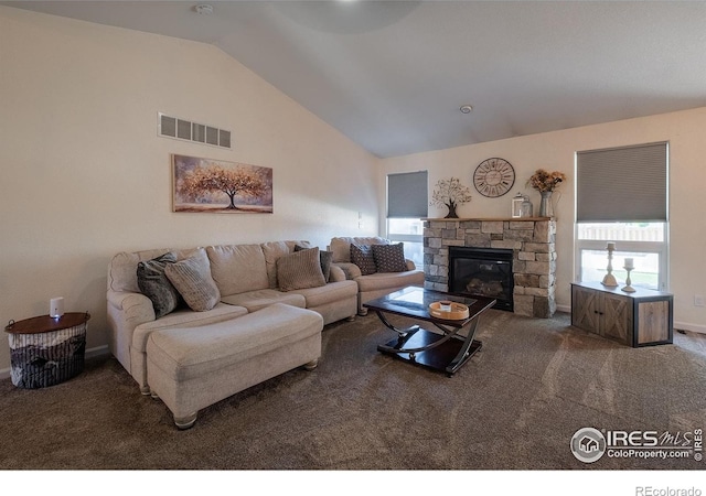 14053 Cottonwood Cir, Sterling, CO 80751 - living area with vaulted ceiling, carpet flooring, and a stone fireplace