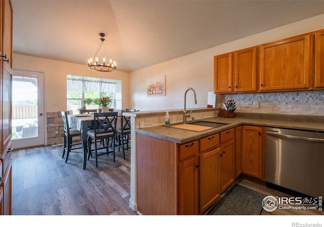 14053 Cottonwood Cir, Sterling, CO 80751 - kitchen featuring dishwasher, brown cabinets, dark wood finished floors, a chandelier, and a peninsula