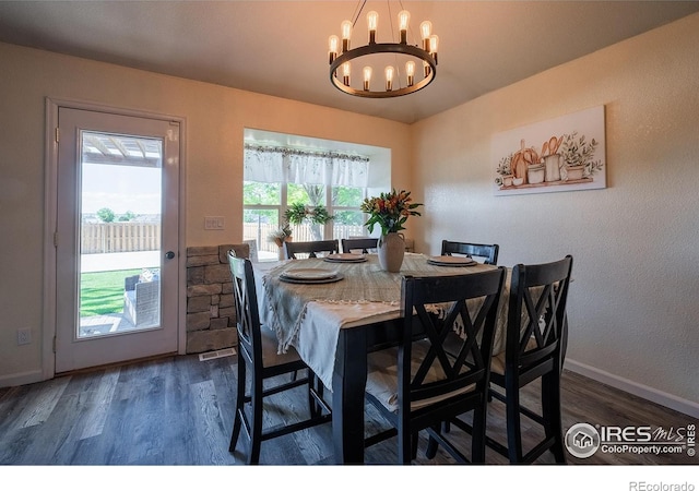 14053 Cottonwood Cir, Sterling, CO 80751 - dining room featuring a chandelier and wood finished floors