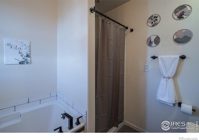 14053 Cottonwood Cir, Sterling, CO 80751 - bathroom with a garden tub and a shower with shower curtain