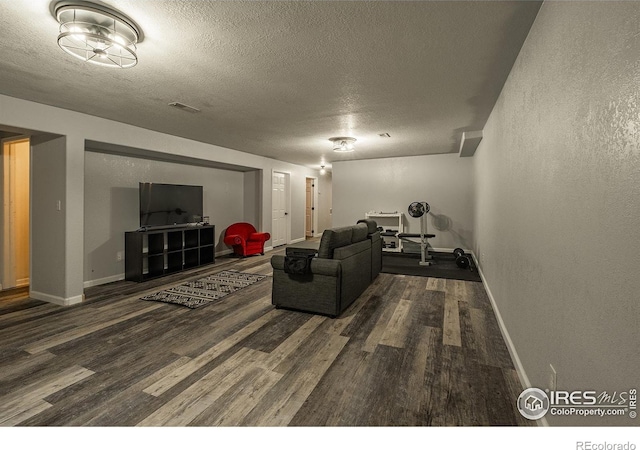 14053 Cottonwood Cir, Sterling, CO 80751 - living room featuring wood finished floors, a textured ceiling, and a textured wall