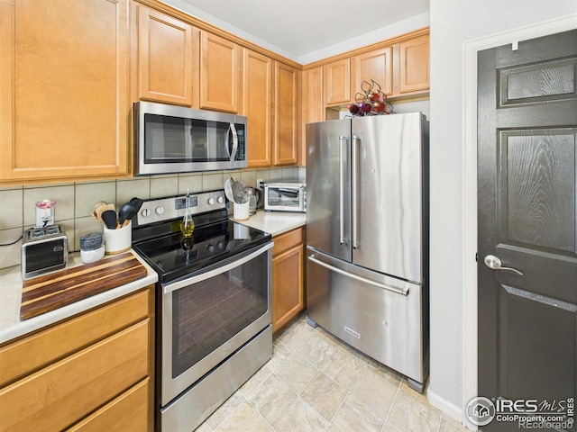 12912 Grant Cir E # A, Thornton, CO 80241 - kitchen with stainless steel appliances, decorative backsplash, and light countertops