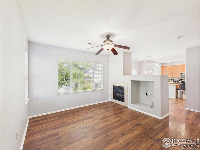 12912 Grant Cir E # A, Thornton, CO 80241 - unfurnished living room with dark wood finished floors, a ceiling fan, and a fireplace