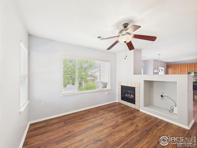 12912 Grant Cir E # A, Thornton, CO 80241 - unfurnished living room featuring ceiling fan, dark wood finished floors, and a fireplace