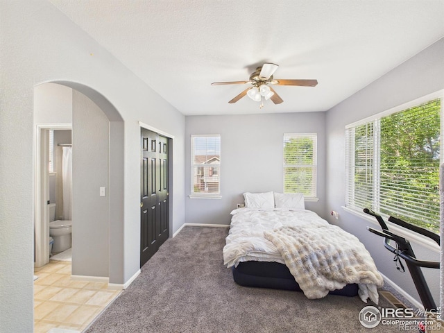12912 Grant Cir E # A, Thornton, CO 80241 - bedroom featuring multiple windows, arched walkways, a closet, and ceiling fan