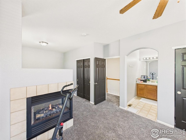 12912 Grant Cir E # A, Thornton, CO 80241 - carpeted living room featuring arched walkways and a fireplace