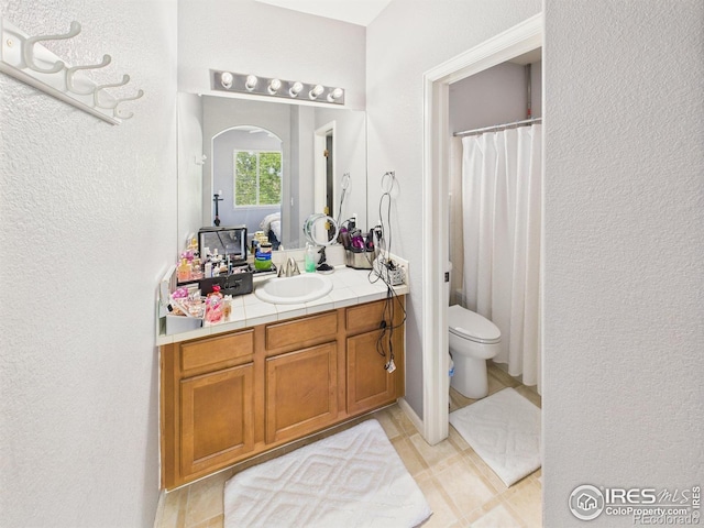 12912 Grant Cir E # A, Thornton, CO 80241 - full bathroom featuring vanity, a textured wall, tile patterned flooring, and a shower with shower curtain