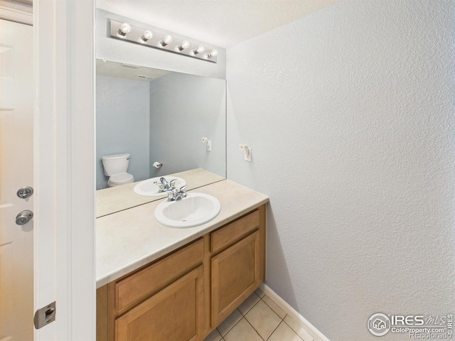 12912 Grant Cir E # A, Thornton, CO 80241 - bathroom featuring vanity, tile patterned floors, and a textured wall