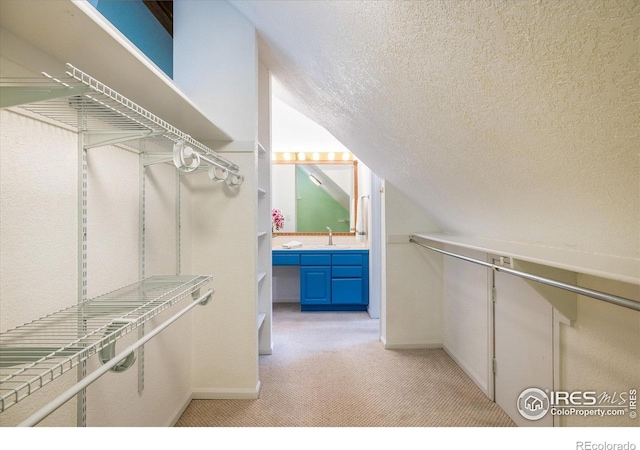 1605 17th St, Boulder, CO 80302 - spacious closet featuring light colored carpet and vaulted ceiling