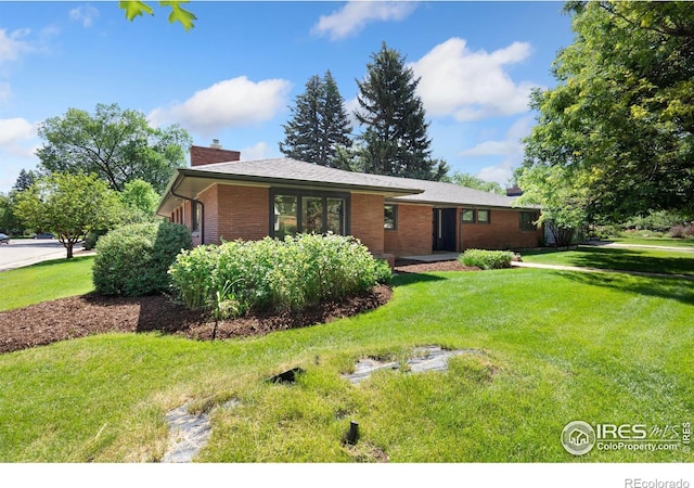600 Monte Vista Ave, Fort Collins, CO 80521 - rear view of house with a chimney, a lawn, and brick siding