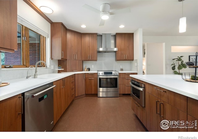 600 Monte Vista Ave, Fort Collins, CO 80521 - kitchen featuring appliances with stainless steel finishes, wall chimney exhaust hood, decorative backsplash, light countertops, and brown cabinets