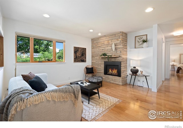 600 Monte Vista Ave, Fort Collins, CO 80521 - living room with light wood-style flooring, a stone fireplace, and recessed lighting
